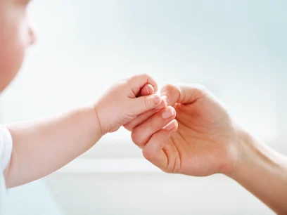 Adult holding a child’s hand